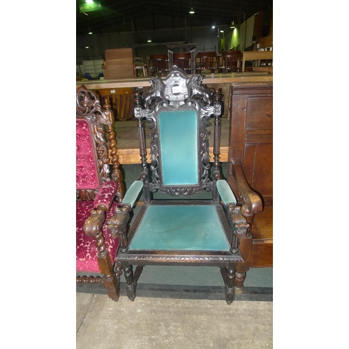 781 - A carved oak elbow chair with lion motif, carved lion elbows & green upholstery