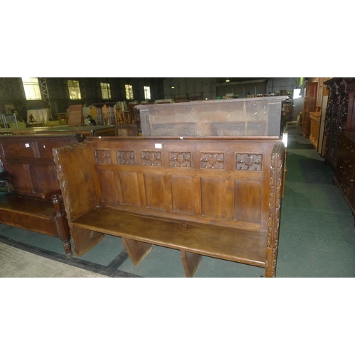 783 - A heavily carved oak 3 seater settle with baronial plaques