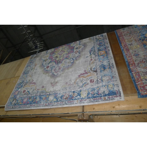 704 - A large horn ground multi-coloured medallion carpet