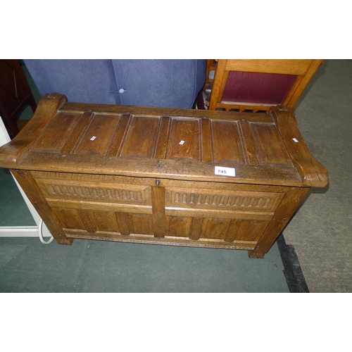 745 - A carved oak coffer with a lift lid