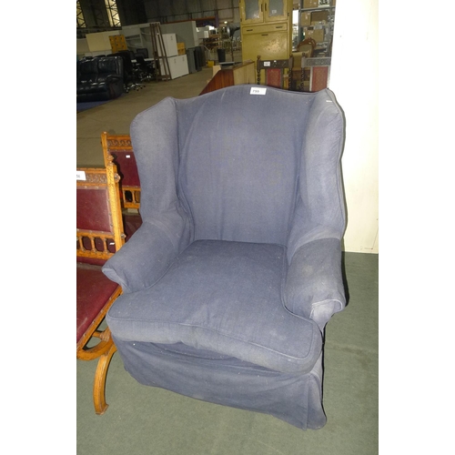 755 - A wing armchair with blue loose covers