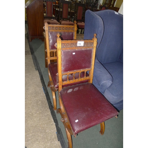 756 - A pair of Edwardian carved oak ecclesiastical style chairs