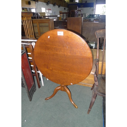 758 - An oak tip-up pedestal table on a tripod base