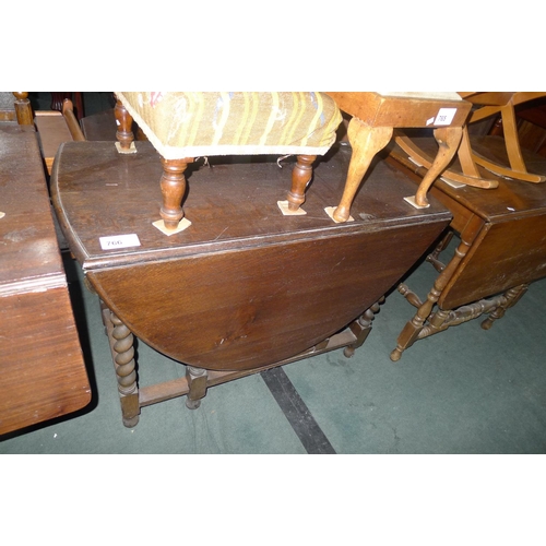 766 - A dark oak oval topped gateleg table with twisted legs