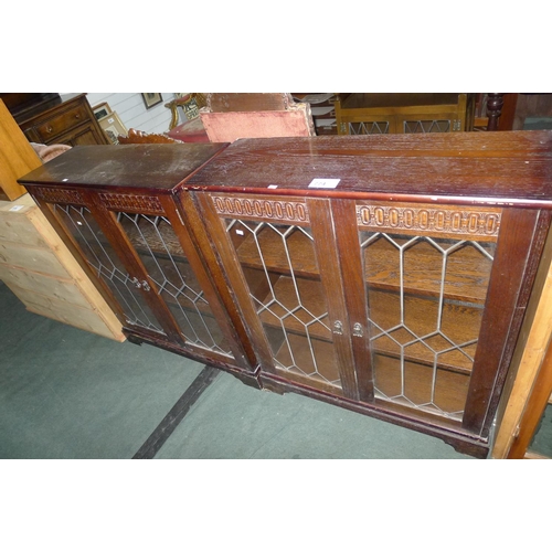 774 - A pair of reproduction dark oak display cabinets each with two leaded glazed doors