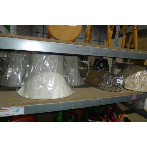 66 - A quantity of various lamp shades. Contents of one shelf