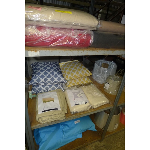 73 - A quantity of various items including cushions, covers etc. Contents of one bay / 3 shelves