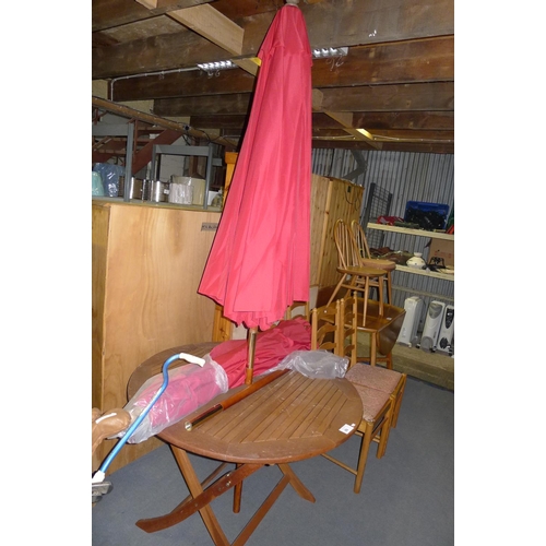 89 - 1 circular wooden garden table and 2 red parasols