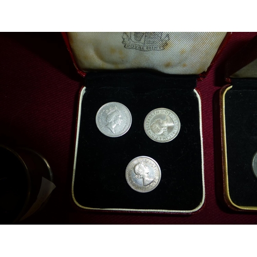 606 - A small quantity of Maundy money, a silver salt with spoon and a silver backed brush