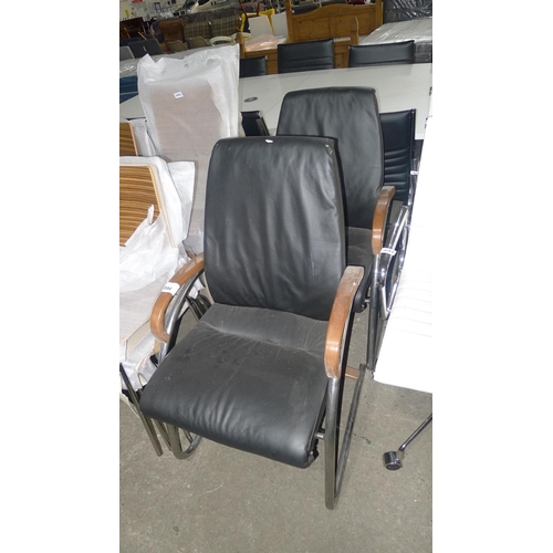 1094 - 2 black upholstered cantilever chairs