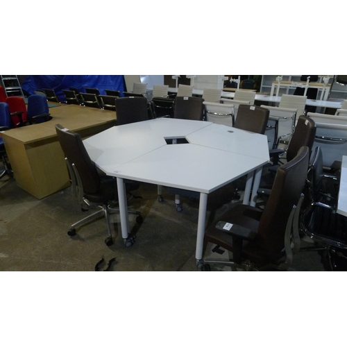 1126 - A white four section octagonal shaped meeting room table comprising of 4 smaller tipping top tables ... 