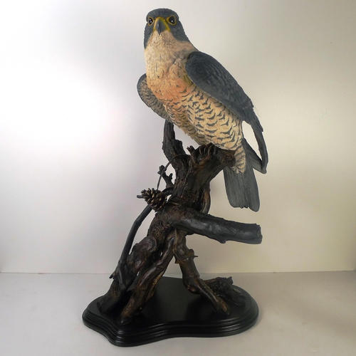 111 - A large resin figure of a bird of prey, 65cm tall