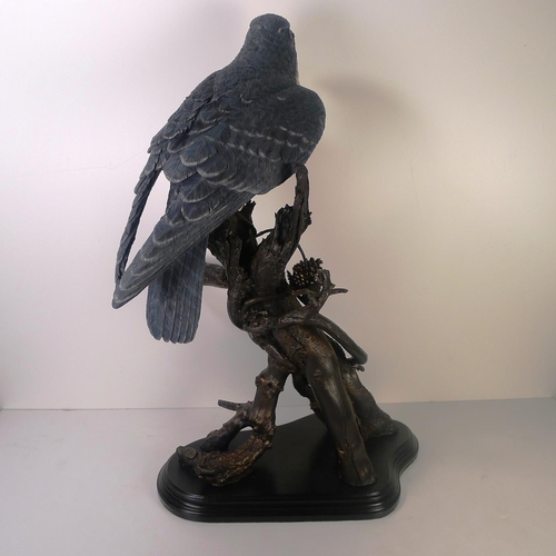 111 - A large resin figure of a bird of prey, 65cm tall