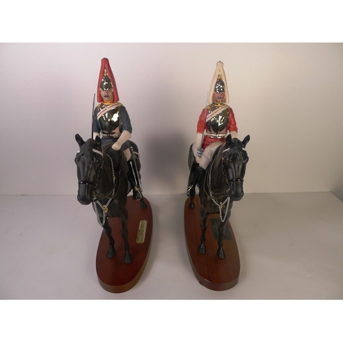 122 - A Beswick figure of a mounted lifeguard officer and a Royal Doulton figure of a mounted blues & roya... 