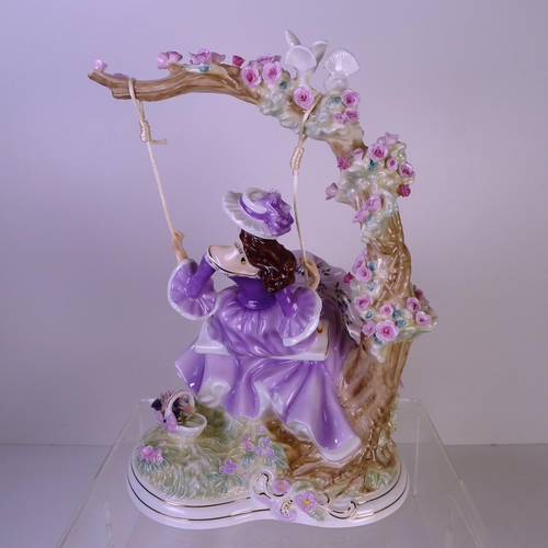 135 - A Royal Worcester figurine of a lady on a swing 