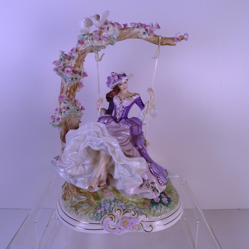 158 - A Royal Worcester figurine of a lady on a swing 