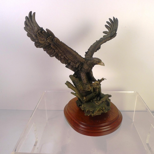 170 - A bronze coloured resin bird of prey, 24 cm tall