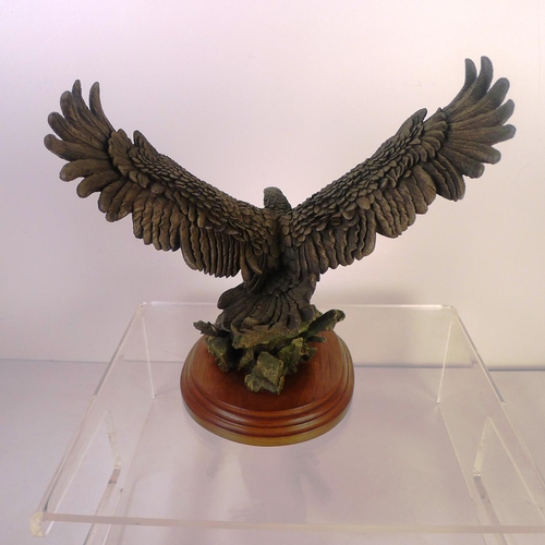 170 - A bronze coloured resin bird of prey, 24 cm tall