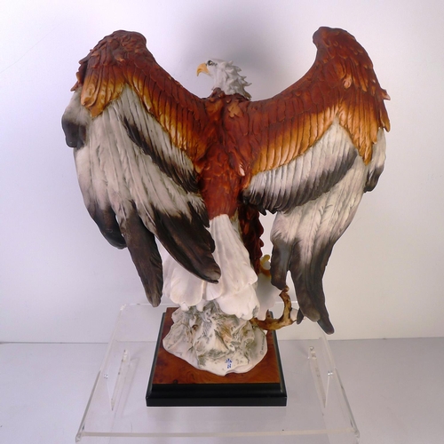 185 - A resin bird of prey, 39cm tall