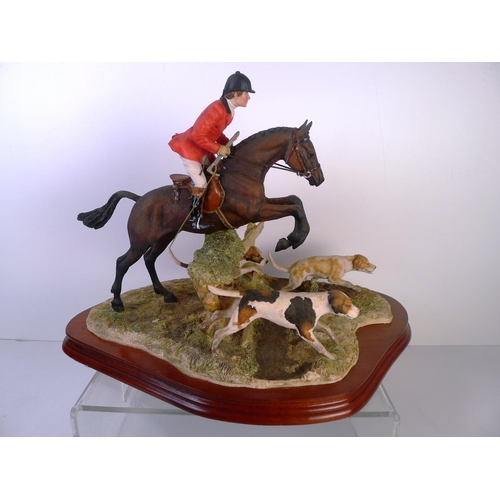 186 - A Border Fine Arts huntsman with Hounds, 30cm tall 