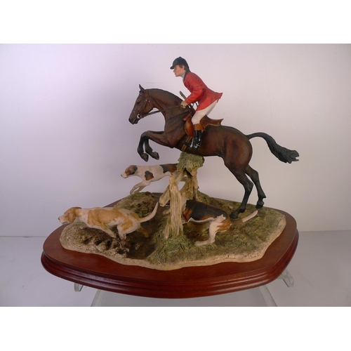 186 - A Border Fine Arts huntsman with Hounds, 30cm tall 