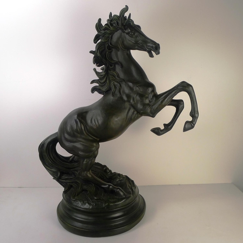 213 - A large bronze coloured resin rearing horse, 66cm tall