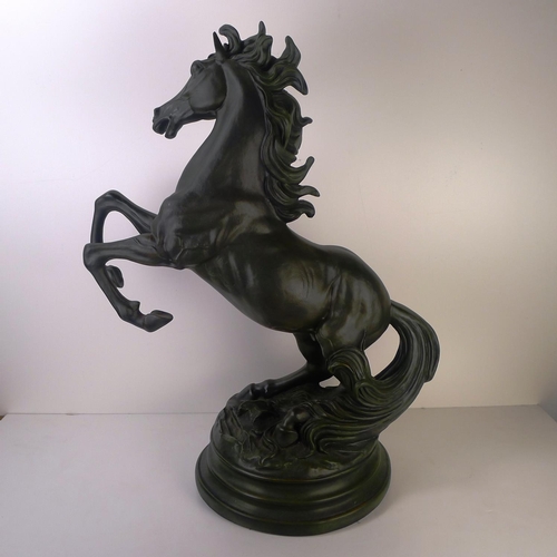 213 - A large bronze coloured resin rearing horse, 66cm tall