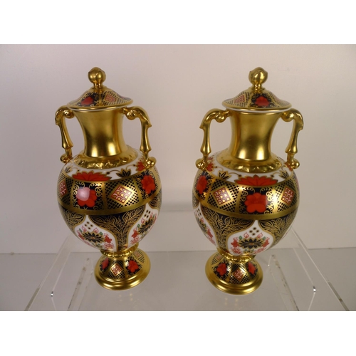 349 - A pair of Royal Crown Derby old Imari 1128 Sudbury vases with covers, 20cm tall. With boxes