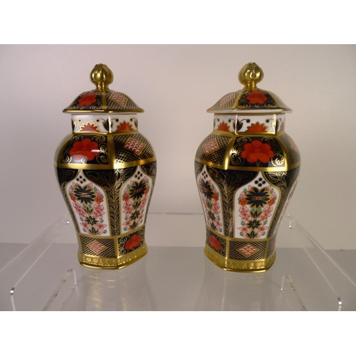 381 - A pair of Royal Crown Derby old Imari 1128 hexagonal jars with covers, 17cm tall