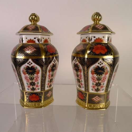 395 - A pair of Royal Crown Derby old Imari 1128 hexagonal jars with covers, 17cm tall