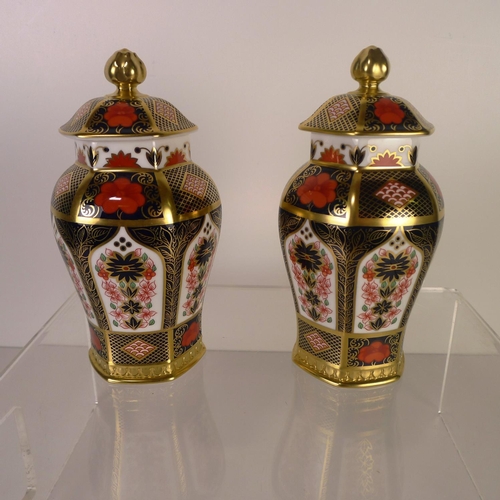 395 - A pair of Royal Crown Derby old Imari 1128 hexagonal jars with covers, 17cm tall