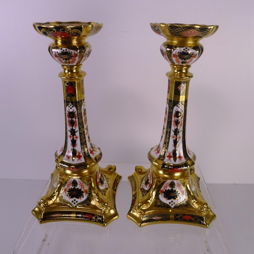 412 - A pair of Royal Crown Derby old Imari 1128 dolphin based candlesticks, 28cm tall, with boxes