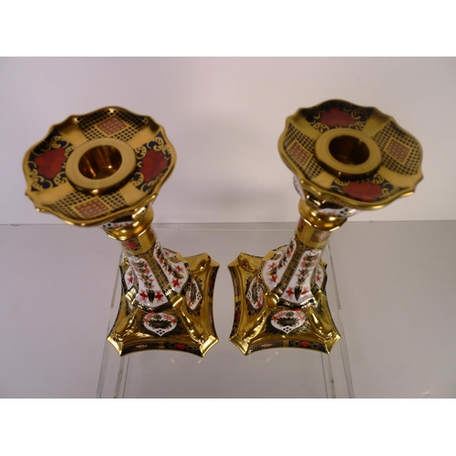 412 - A pair of Royal Crown Derby old Imari 1128 dolphin based candlesticks, 28cm tall, with boxes