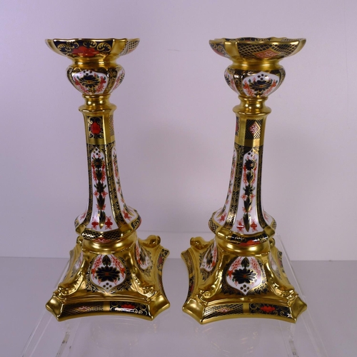 412 - A pair of Royal Crown Derby old Imari 1128 dolphin based candlesticks, 28cm tall, with boxes