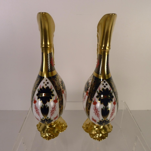 425 - A pair of Royal Crown Derby old Imari 1128 swan neck pitchers, 26 cm tall, with boxes