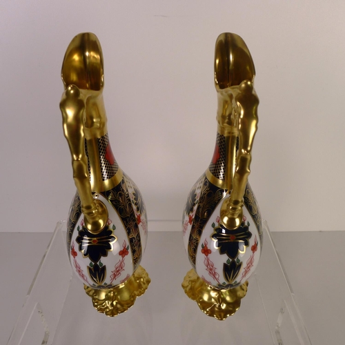 425 - A pair of Royal Crown Derby old Imari 1128 swan neck pitchers, 26 cm tall, with boxes