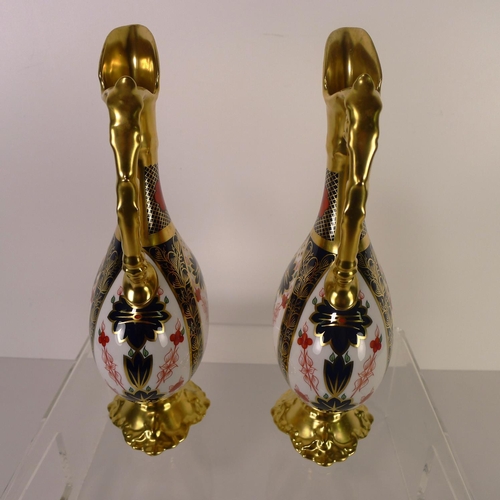 440 - A pair of Royal Crown Derby old Imari 1128 swan neck pitchers, 26cm tall, with boxes