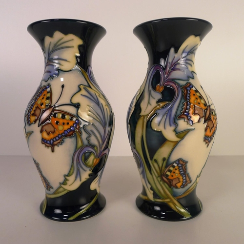 467 - A pair of modern Moorcroft pottery vases, 20cm tall, decorated with butterflies & foliage, painted m... 