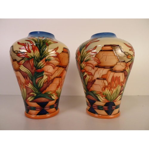 468 - A pair of modern Moorcroft pottery vases, 22cm tall, decorated with stonework & foliage, impressed &... 