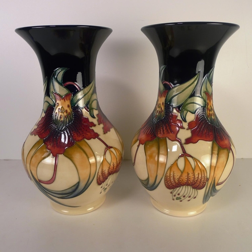 471 - A pair of modern Moorcroft pottery vases, 33cm tall, decorated with flowers & foliage, impressed & p... 