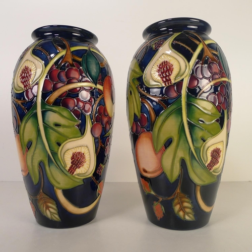 481 - A pair of modern Moorcroft pottery vases, 25cm tall, decorated with fruit & foliage, impressed & pai... 
