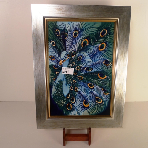 539 - A modern Moorcroft pottery framed tile plaque, 40cm x 30cm overall, decorated with a peacock, impres... 