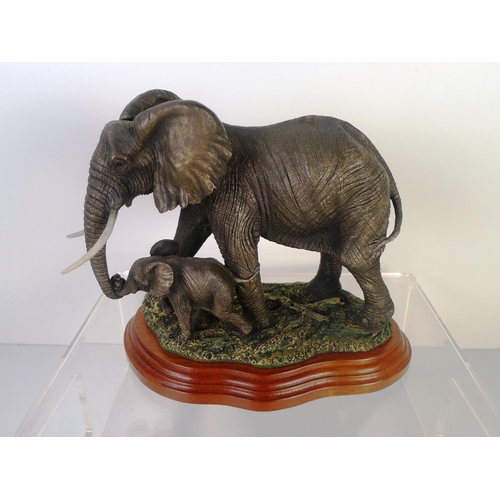 78 - A bronze coloured resin elephant and calf, 18cm tall