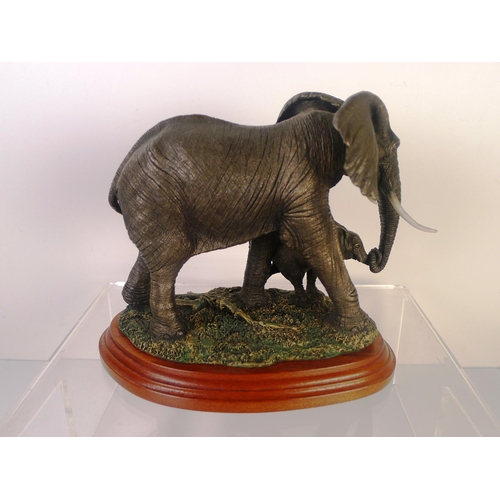 78 - A bronze coloured resin elephant and calf, 18cm tall