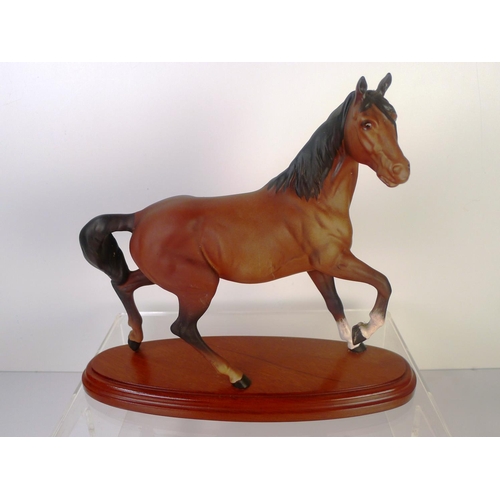 83 - A Beswick horse on wooden plinth, 24cm tall