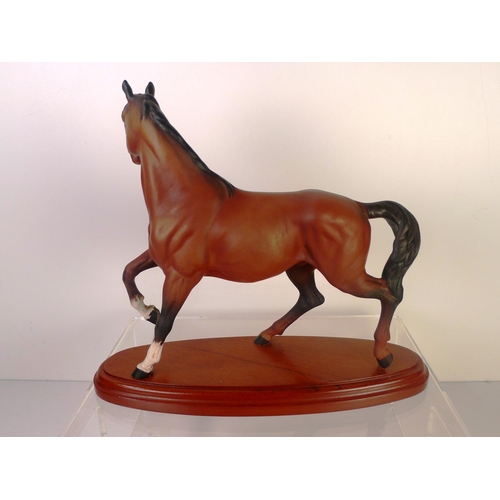 83 - A Beswick horse on wooden plinth, 24cm tall