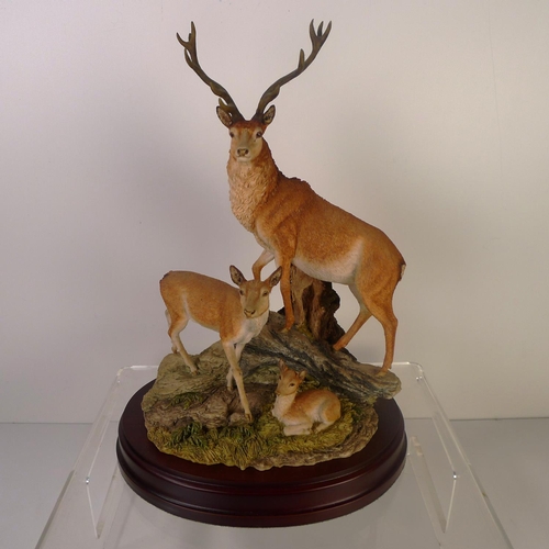 90 - A Sherratt and Simpson resin group of deer, 30cm tall