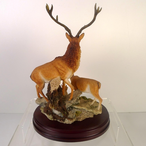 90 - A Sherratt and Simpson resin group of deer, 30cm tall