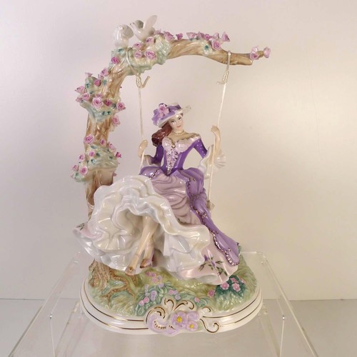 158 - A Royal Worcester figurine of a lady on a swing 