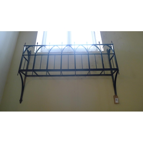 386 - A decorative wrought iron window box, approximately 145cm wide